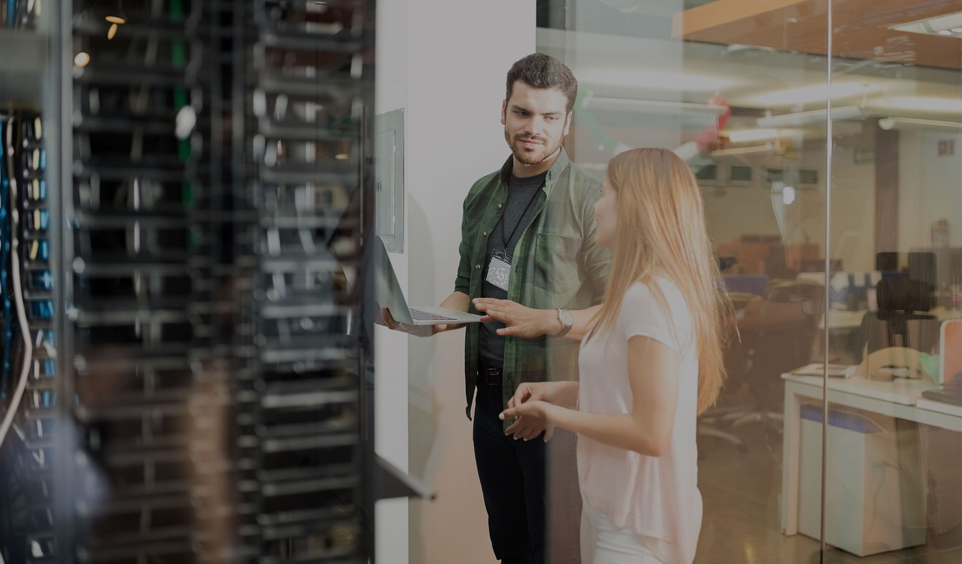 Man assisting woman with her computer