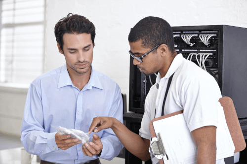 Engineer in front of Router Rack